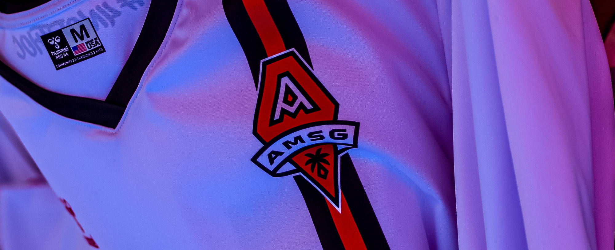 AMSG crest detail on white jersey